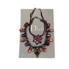 Necklace with colorful stones on a Dior Catwalk book