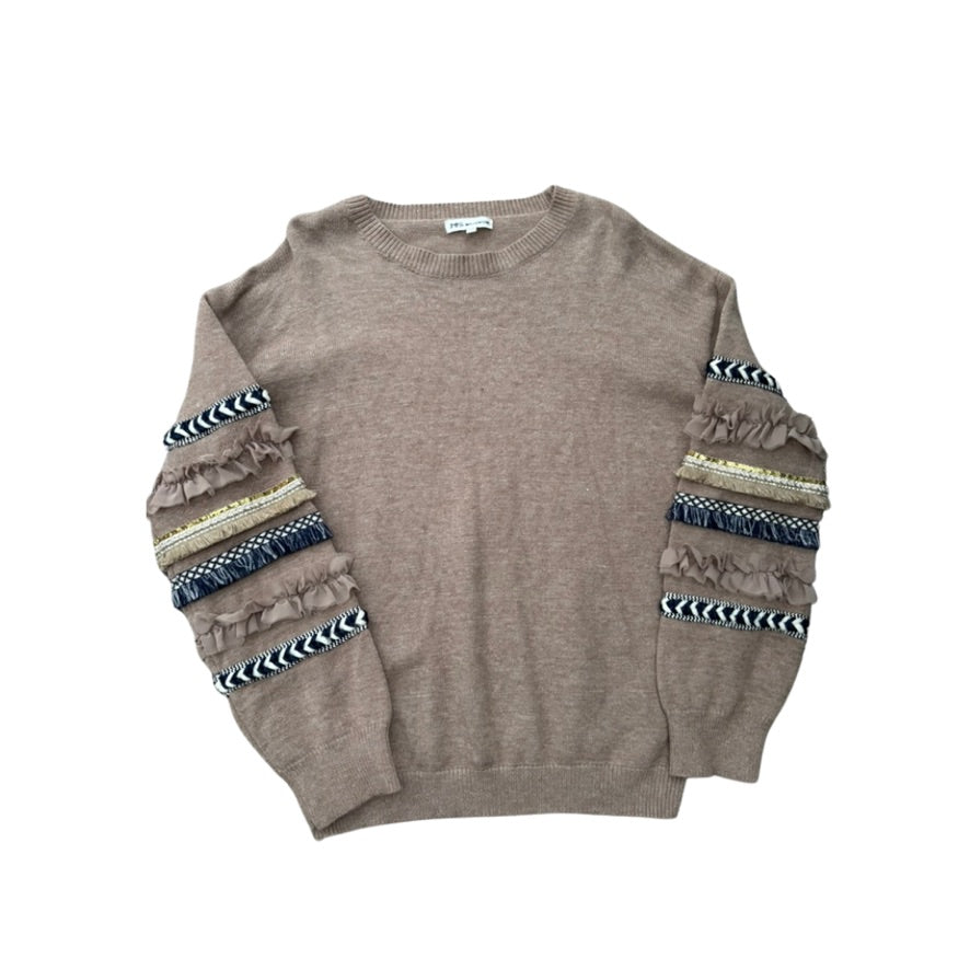 Brown sweater with patterned sleeves on a white background