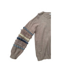 Brown sweater with patterned sleeves on a white background