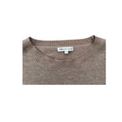 Brown sweater with a brand label on a white background