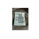 Fabric label with material composition details on a textured fabric background