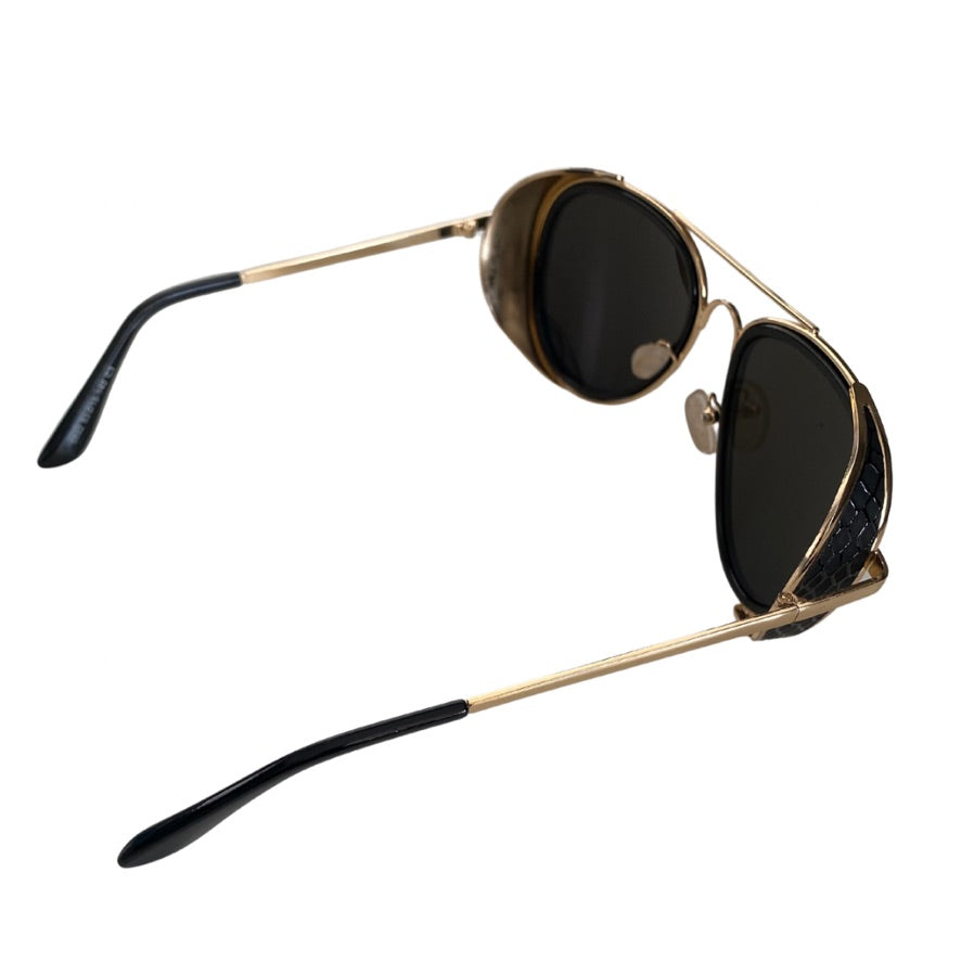 Gold-framed sunglasses with black lenses on a white background