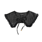 Black quilted collar with ruffles and a bow on a white background