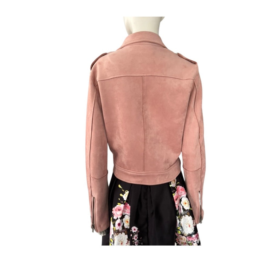 Pink suede jacket on a mannequin with a floral dress underneath on a white background