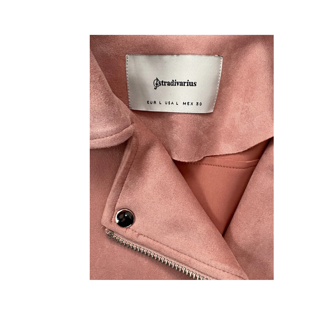 Close-up of a pink jacket with a visible brand label on a white background