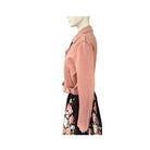 Mannequin wearing a pink jacket and floral skirt on a white background