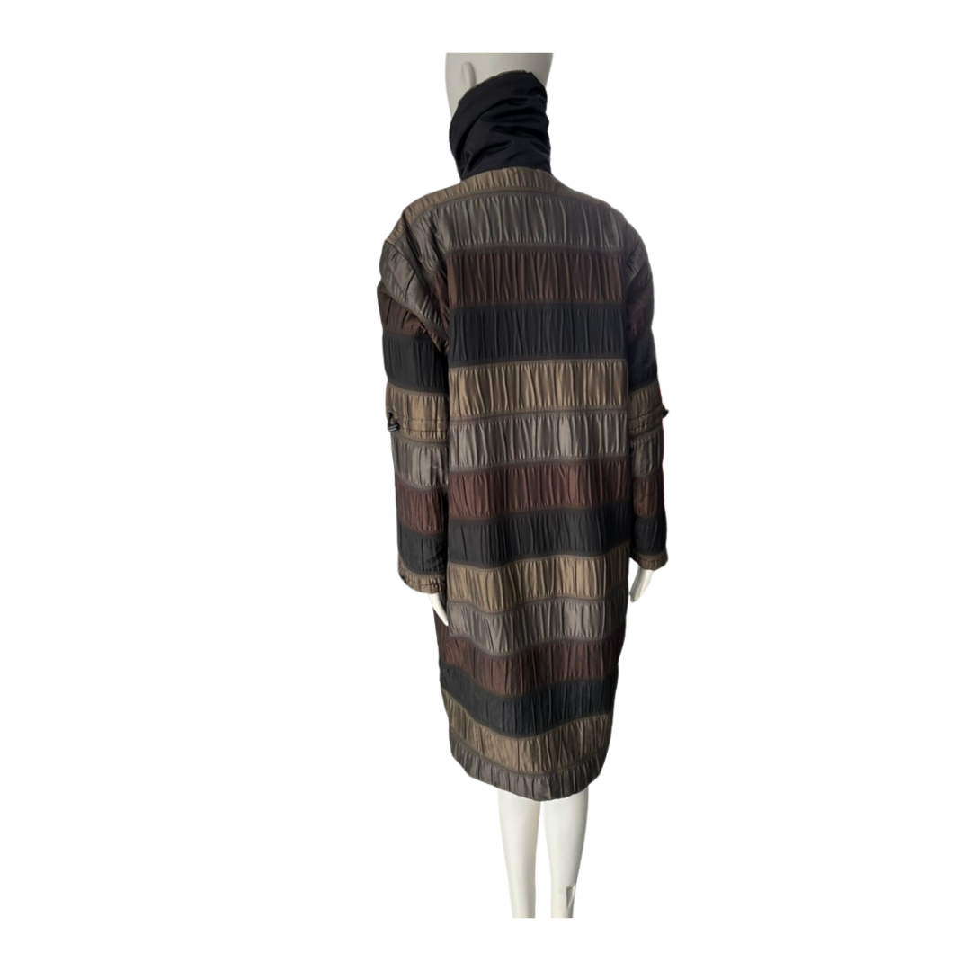 Mannequin wearing a long, striped coat on a white background