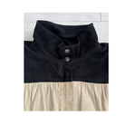 Black and beige dress with a buttoned collar on a white background