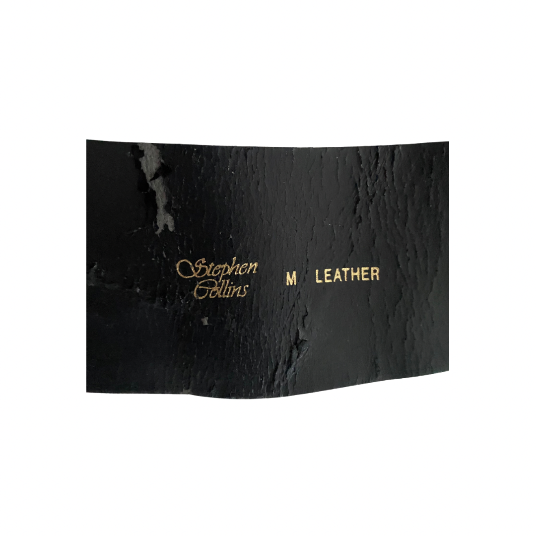Black leather product with 'Stephen Collins' branding on a white background
