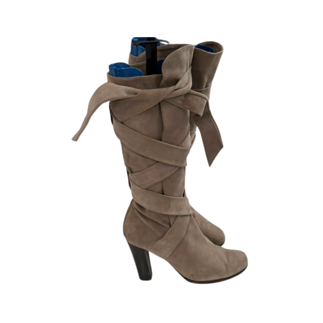 Beige knee-high boots with a wrap-around design on a white background