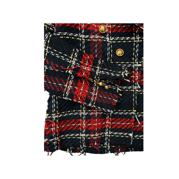 Close-up of a plaid fabric with red, black, and gold colors on a white background.