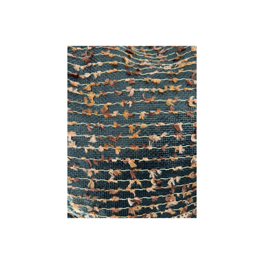 Textured fabric swatch with a pattern of brown, and pink colors on a white background.