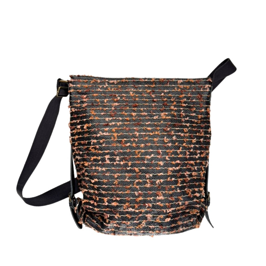 Textured bag with black strap on a white background