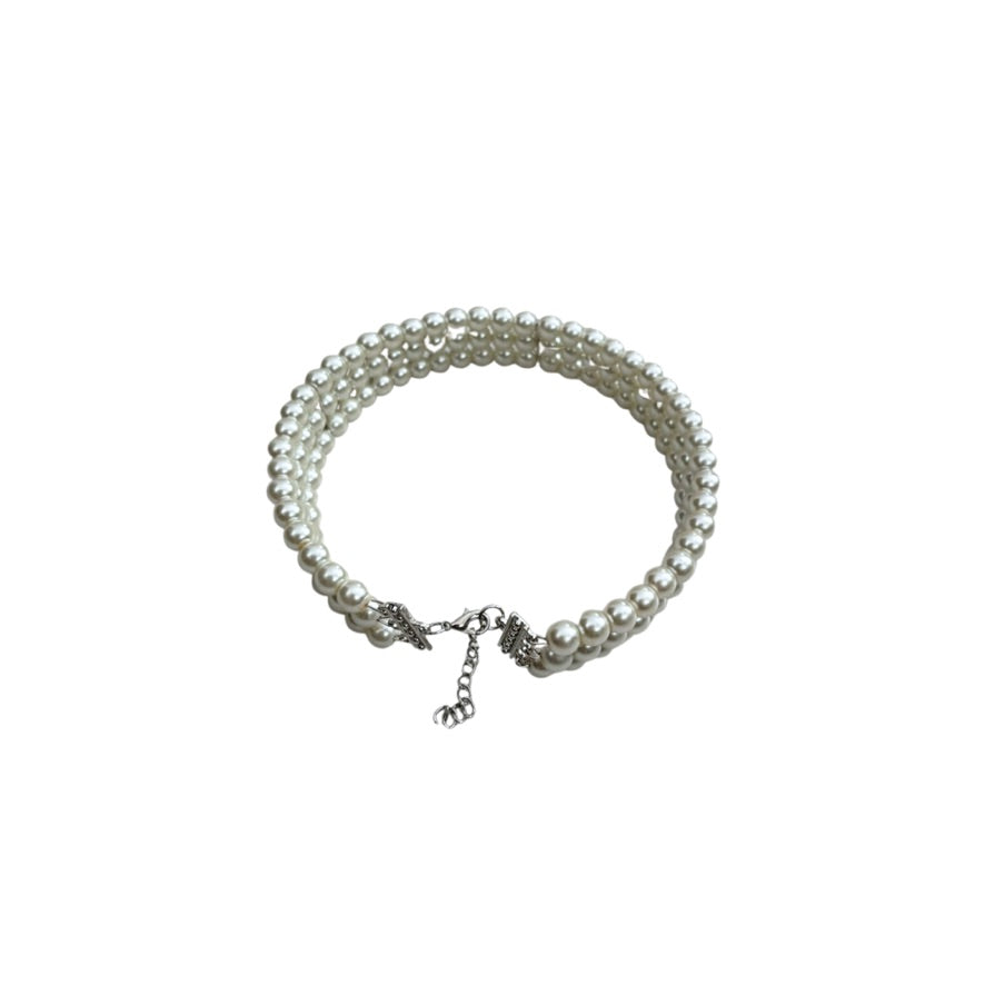 Pearl necklace with a silver clasp on a white background
