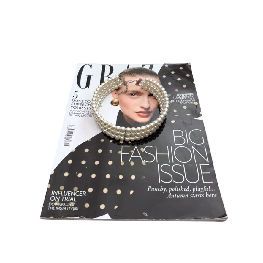 Magazine cover with a woman wearing pearl headbands on a white background