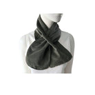 Mannequin wearing a black and beige checkered scarf on a white background