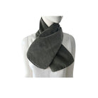 Mannequin wearing a black and beige checkered scarf on a white background