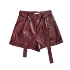 Burgundy leather shorts with a belt on a white background