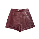 Back of burgundy leather shorts on a white background