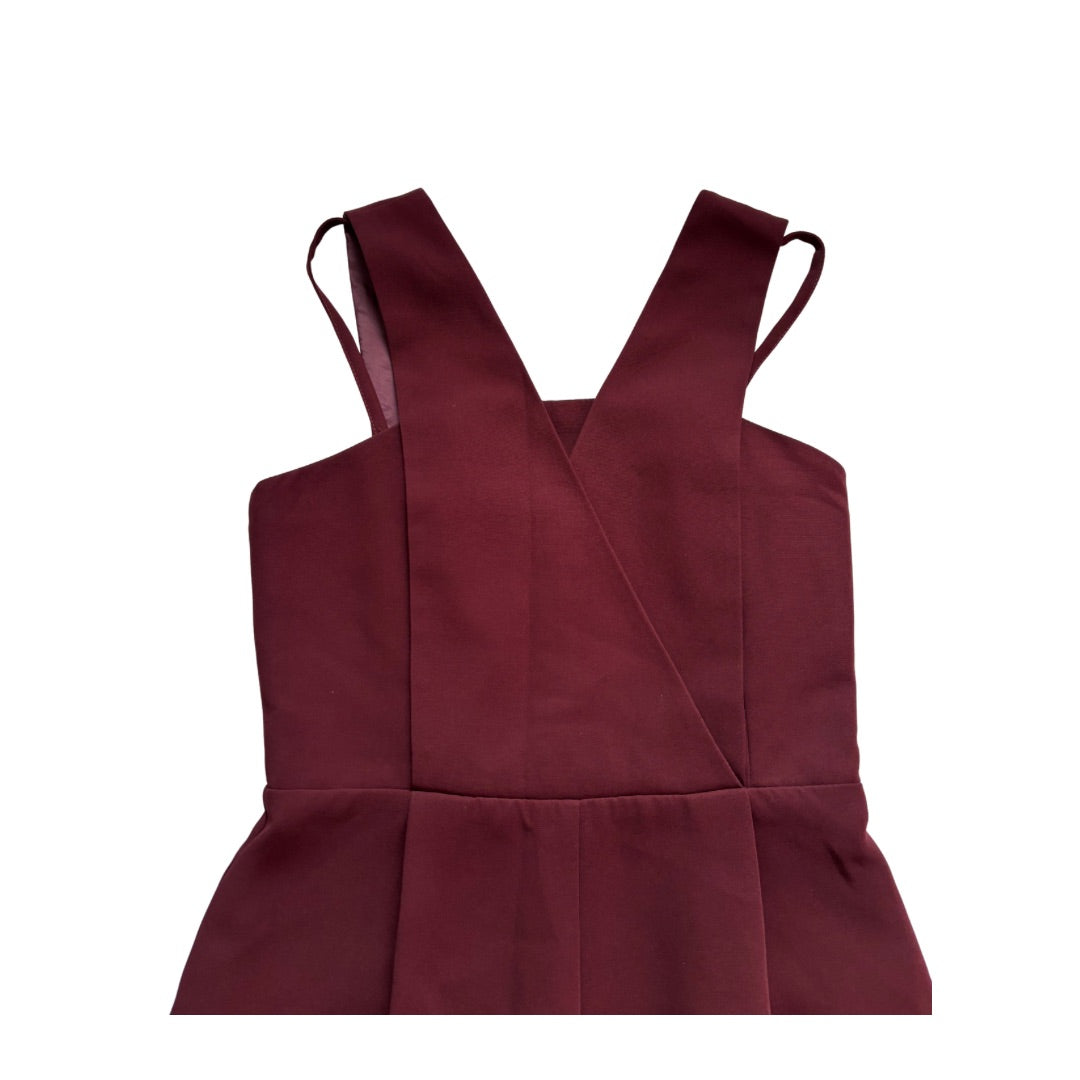 Maroon jumpsuit with a V-neck and straps on a white background