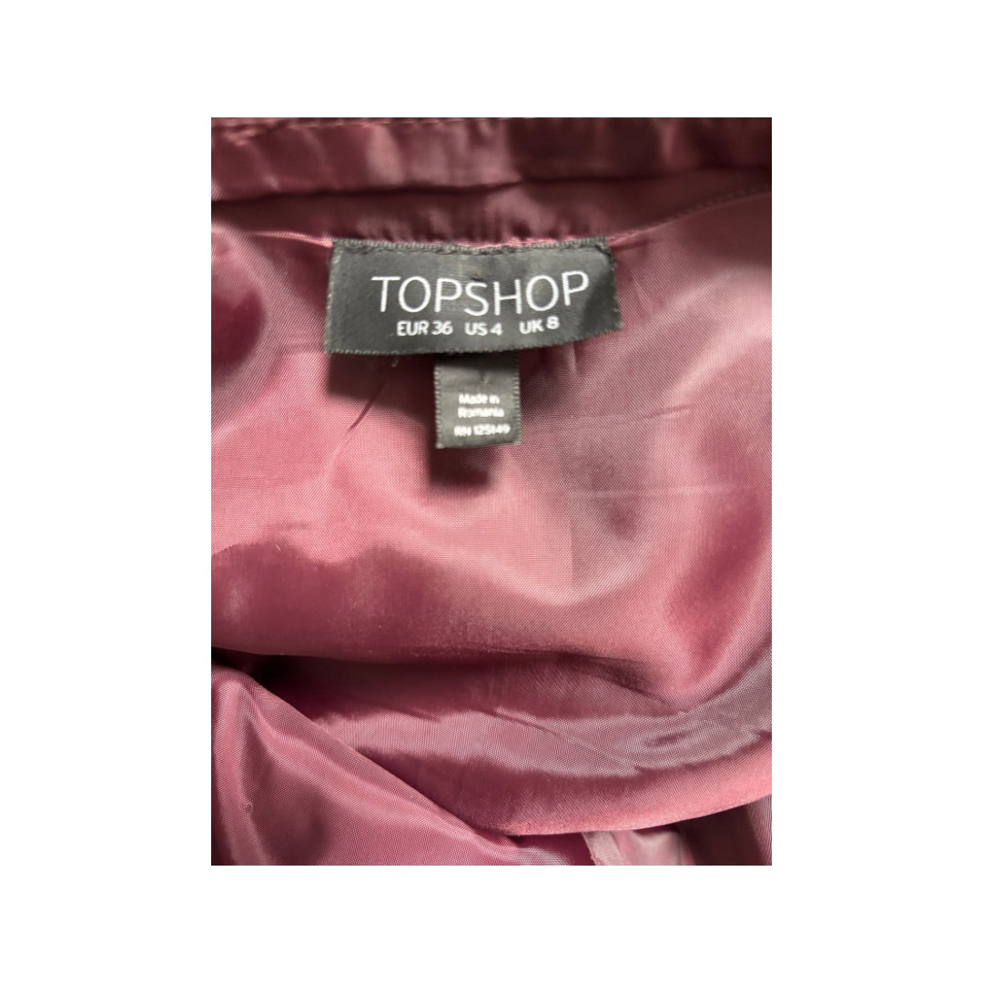 Topshop label on a pink garment with a white background