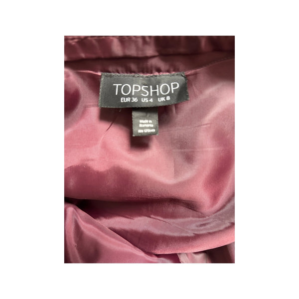 Topshop label on a pink garment with a white background