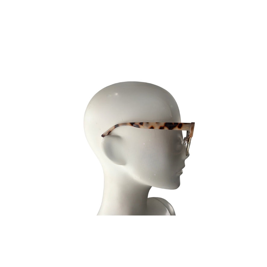 Mannequin head wearing a leopard print headband on a white background