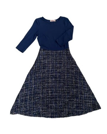 Navy blue top and patterned skirt set on a white background