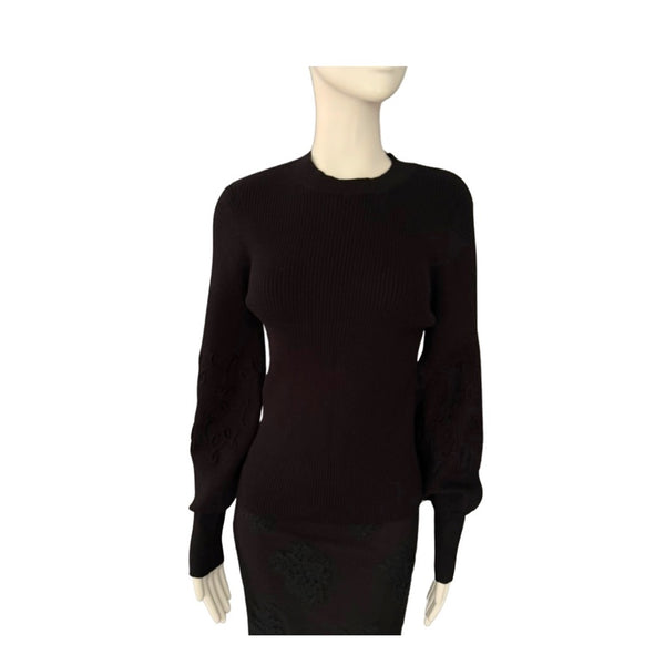 Black sweater on a mannequin against a white background