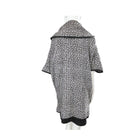 Black and white patterned coat on a mannequin against a white background