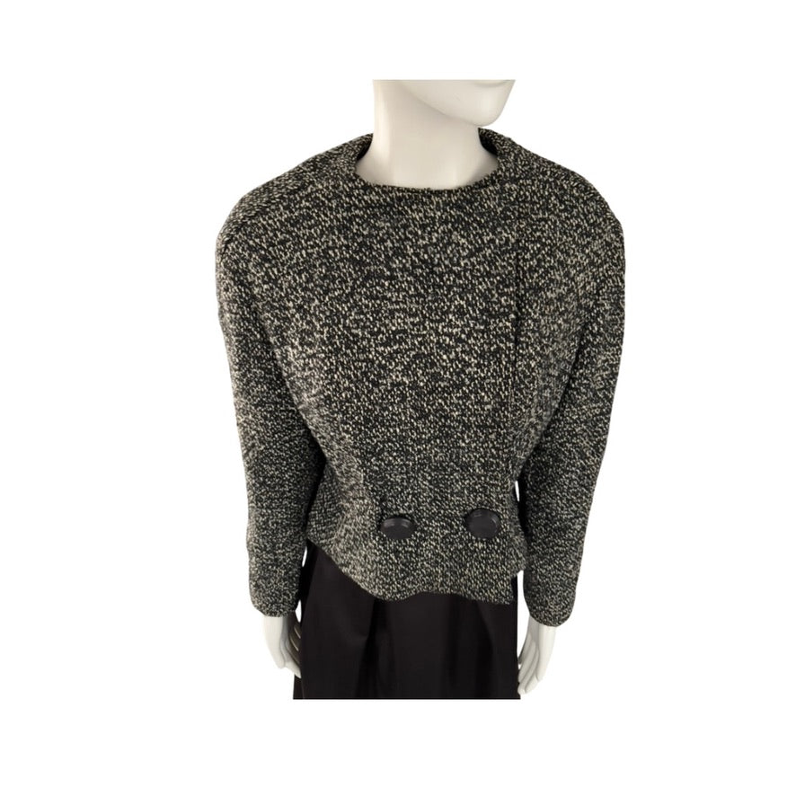 Mannequin wearing a textured black and gray sweater on a white background