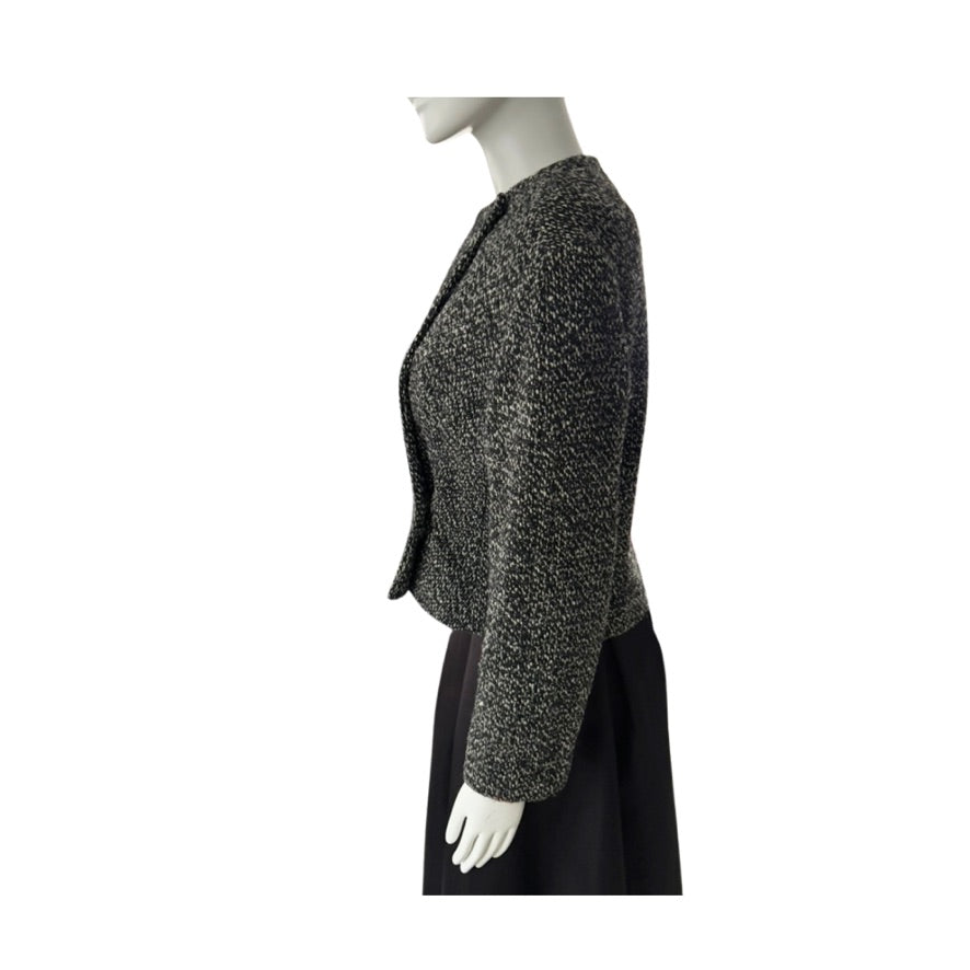 Mannequin wearing a textured gray jacket on a white background