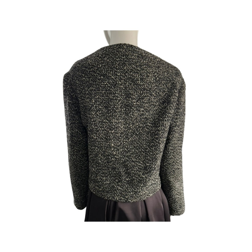 Textured black and gray jacket on a mannequin against a white background