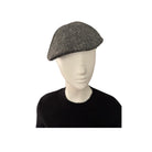 Mannequin head wearing a gray flat cap on a white background