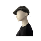 Mannequin head wearing a grey flat cap on a white background