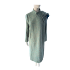 Green coat on a mannequin against a white background