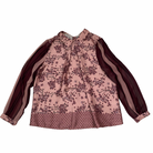 Pink floral blouse with brown accents on a white background