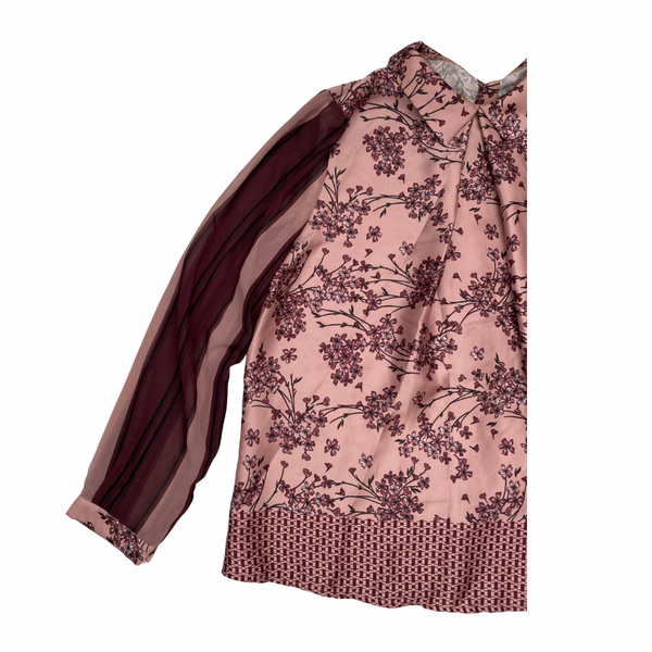 Pink blouse with floral pattern on a white background