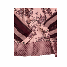 Pink shirt cuffs with floral and geometric patterns on a white background