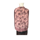 Pink floral blouse on a mannequin against a white background
