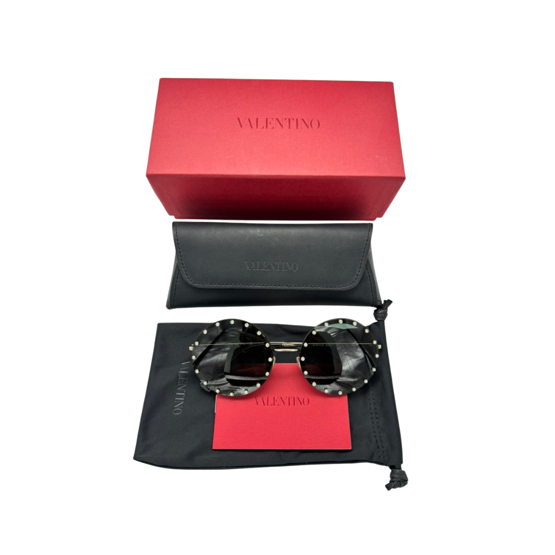 Valentino sunglasses with red and black pouch and box on a white background