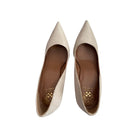 Pair of beige pointed-toe shoes on a white background