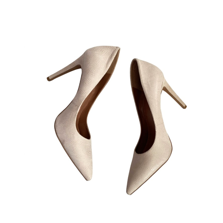 Pair of beige high-heeled shoes on a white background