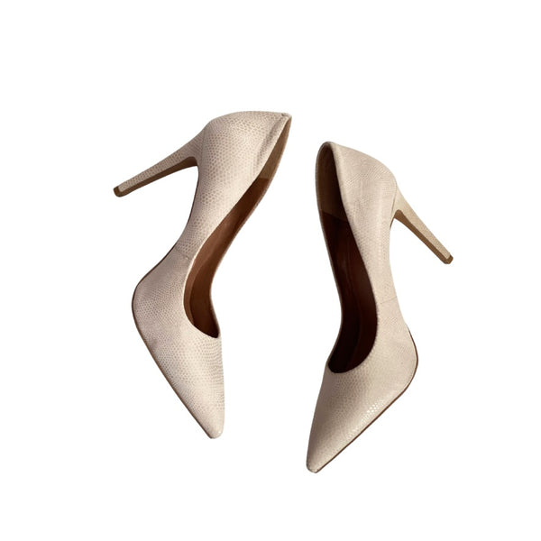 Pair of beige high-heeled shoes on a white background