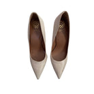Pair of beige high-heeled shoes on a white background