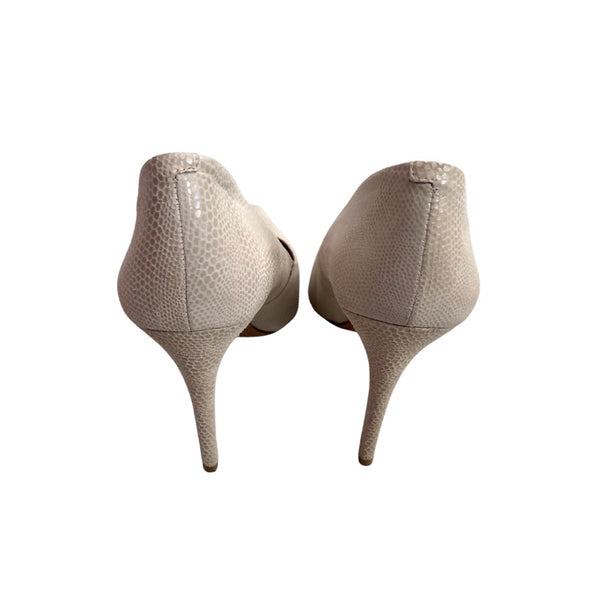 Pair of beige high-heeled shoes on a white background