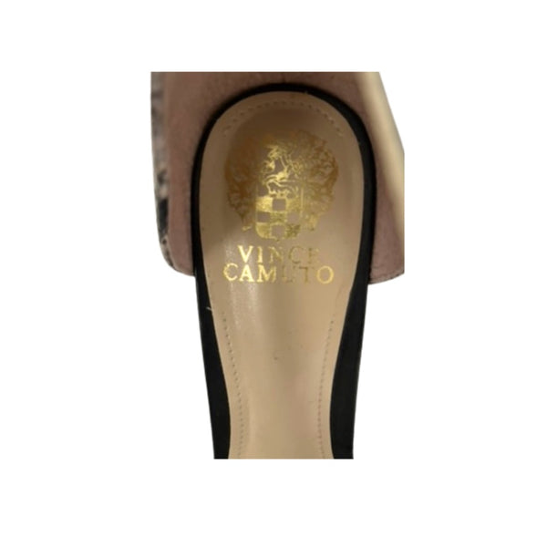 Close-up of a shoe with 'Vince Camuto' logo on a white background