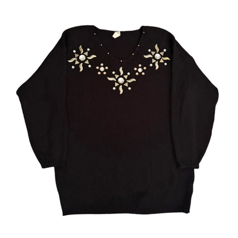 Black sweater with gold embellishments on a white background