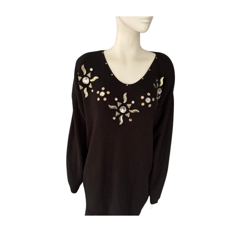 Black sweater with gold embellishments on a mannequin against a white background
