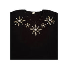 Black top with decorative silver patterns on a white background